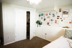 Bedroom featuring a closet and dark carpet