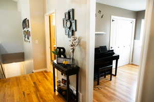 Hallway featuring light wood finished floors