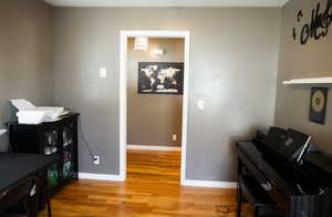 Office area featuring baseboards and light wood finished floors