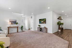 Living room with recessed lighting and carpet flooring