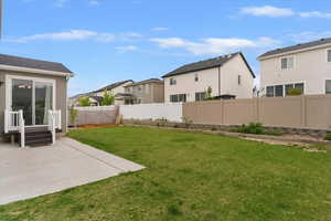 Fenced backyard with a residential view and a patio area