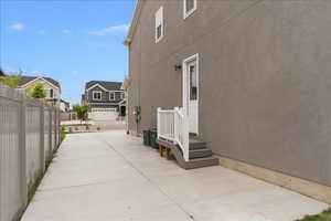 View of side of home with stucco siding and a residential view