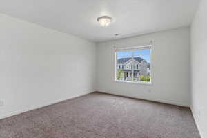 Carpeted empty room with baseboards