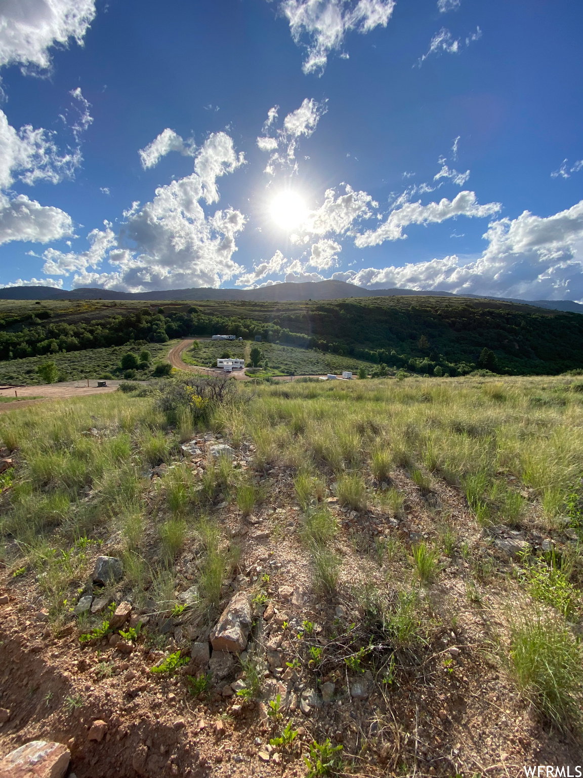 View of mountain backdrop with rural landscape
