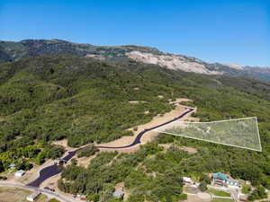 Aerial view of property's location featuring property parcel outlined and a mountainous background