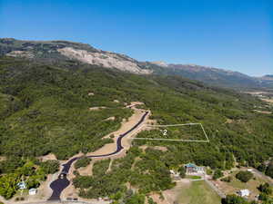 Aerial view of property's location featuring property parcel outlined and a mountain backdrop