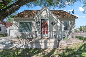 View of front of home with roof with shingles