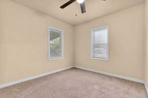 Spare room with light carpet and ceiling fan