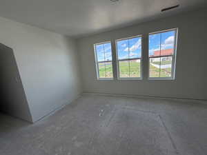 Spare room with plenty of natural light and a textured ceiling