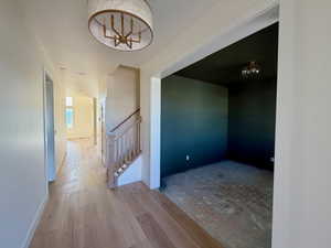 Entry with light wood finished floors and baseboards