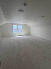 Bonus room featuring baseboards and a textured ceiling