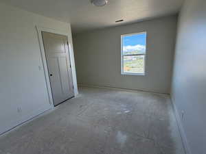 Unfurnished bedroom with baseboards and a textured ceiling