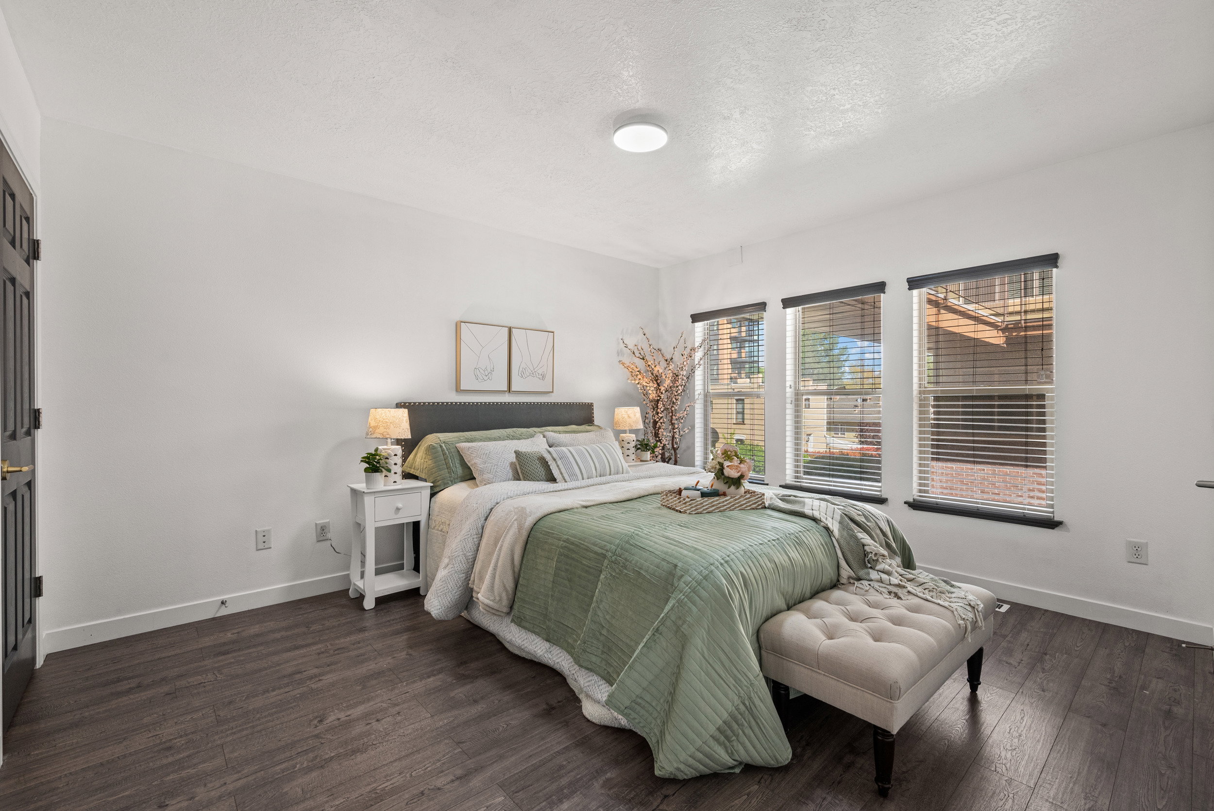 Bedroom with a textured ceiling and dark wood-type flooring