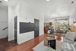 Living room with dark wood-style flooring and recessed lighting