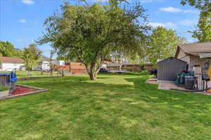 View of yard featuring a storage unit