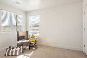 Living area with baseboards and carpet flooring
