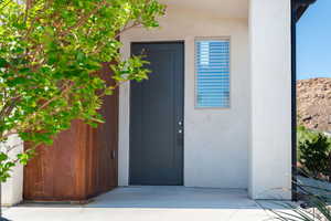 Entrance to property featuring stucco siding