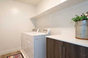 Laundry area with wood finished floors and washing machine and dryer