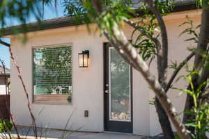 Entrance to property featuring stucco siding