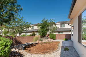 Fenced yard featuring a residential view