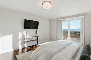 Bedroom with hardwood / wood-style flooring and access to exterior