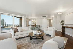 Living area with hardwood / wood-style flooring and baseboards