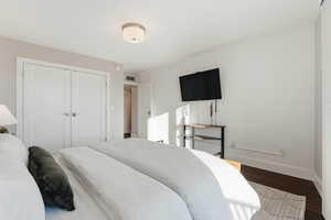 Bedroom featuring hardwood / wood-style floors and a closet