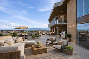 Patio / terrace featuring a patio, a mountain view, an outdoor living / dining area, and an outdoor kitchen
