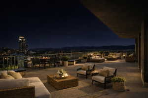 Patio at night featuring a patio and an outdoor living / dining area