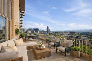 View of patio featuring a city view and an outdoor living / dining area