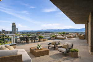 View of patio with outdoor lounge area, a mountain view, and a grill