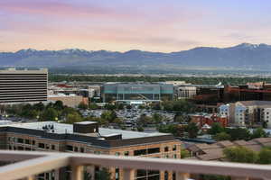 View of mountain backdrop featuring nearby urban area