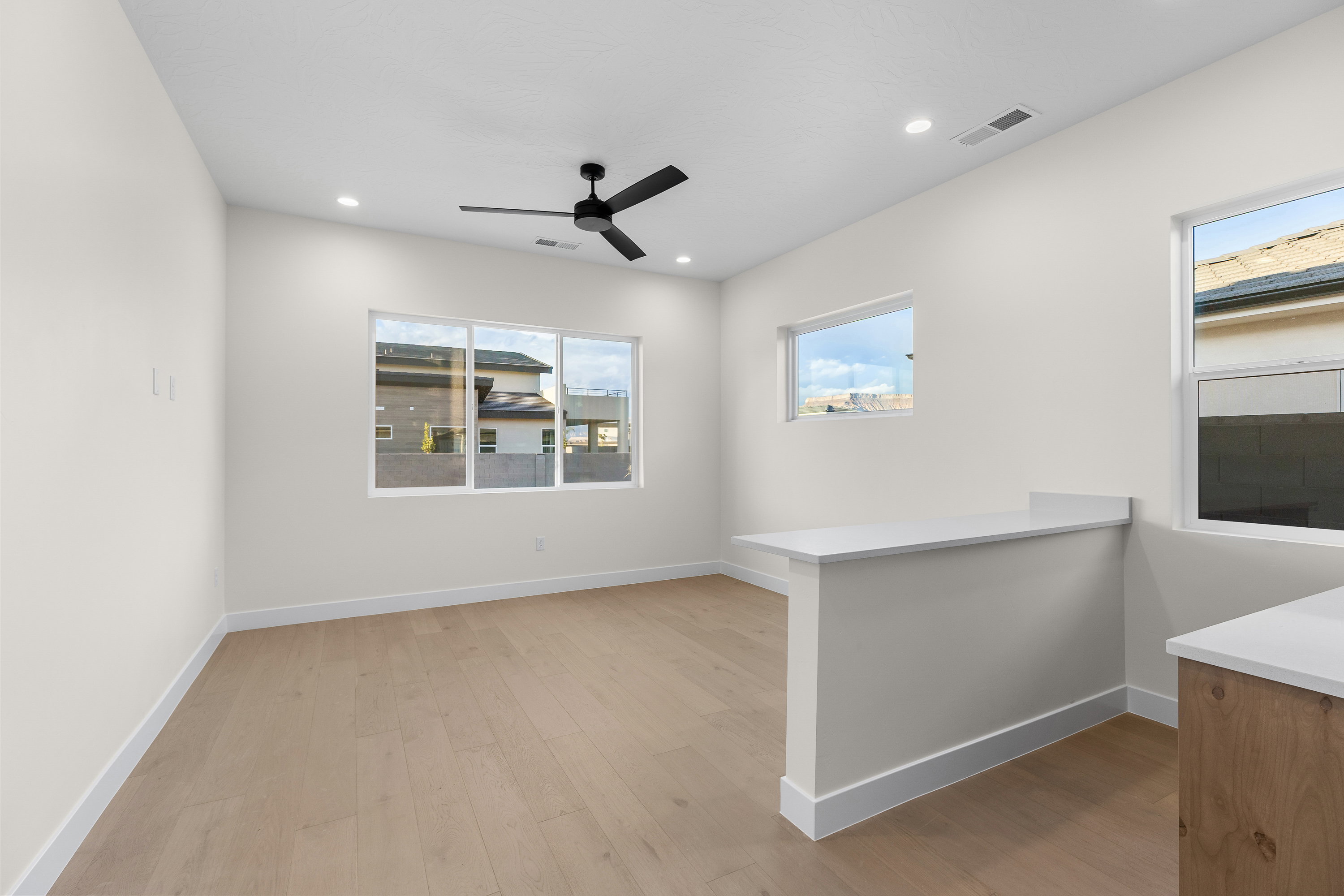 Unfurnished room with light wood-type flooring, a ceiling fan, and recessed lighting