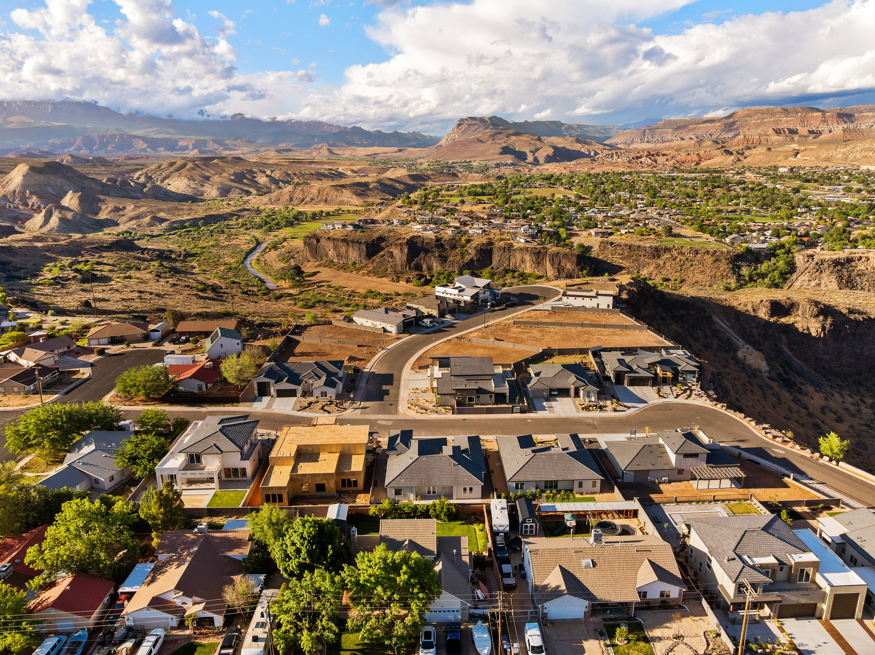 Aerial perspective of suburban area with a mountainous background