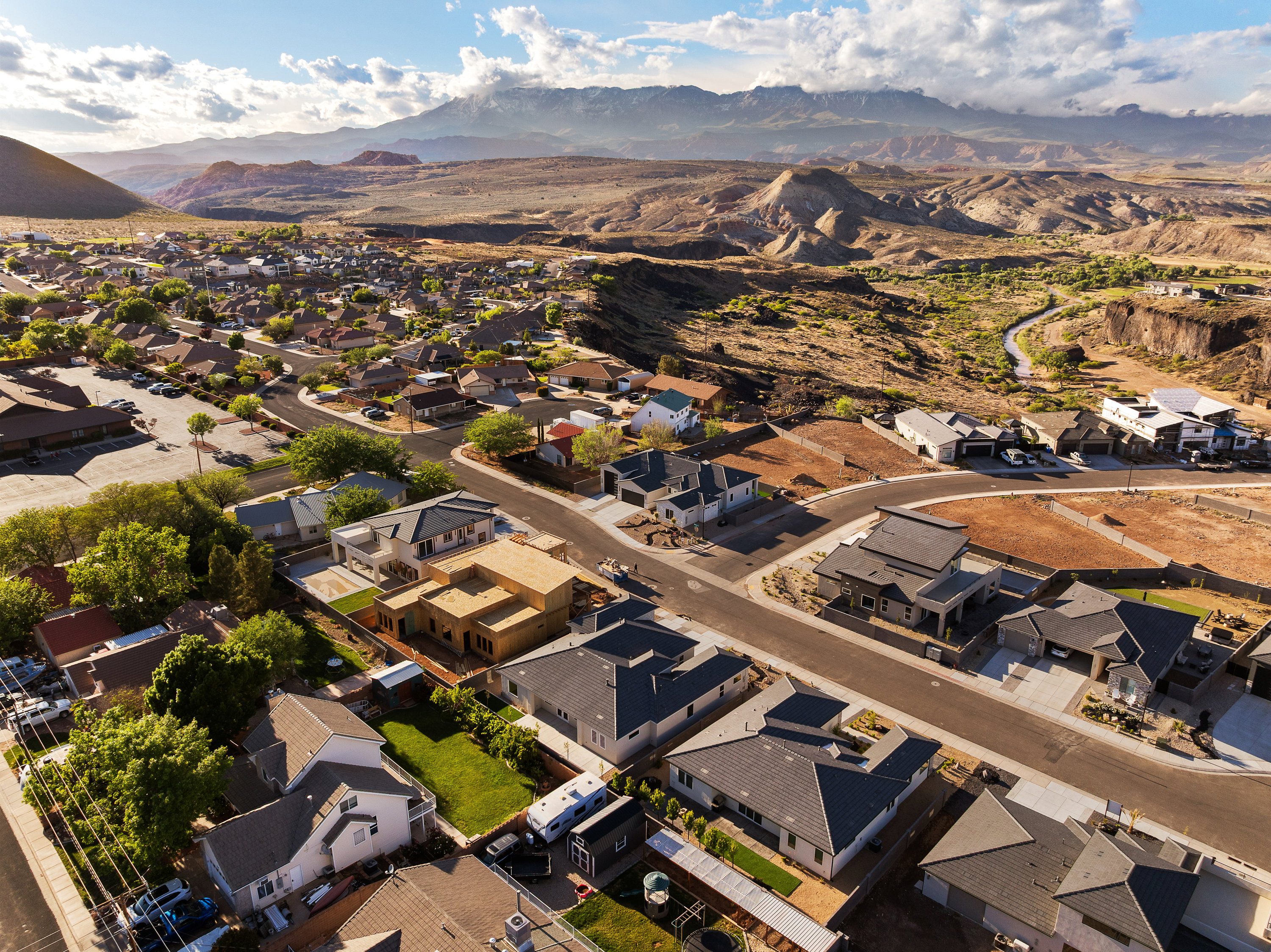 Aerial perspective of suburban area featuring a mountain backdrop