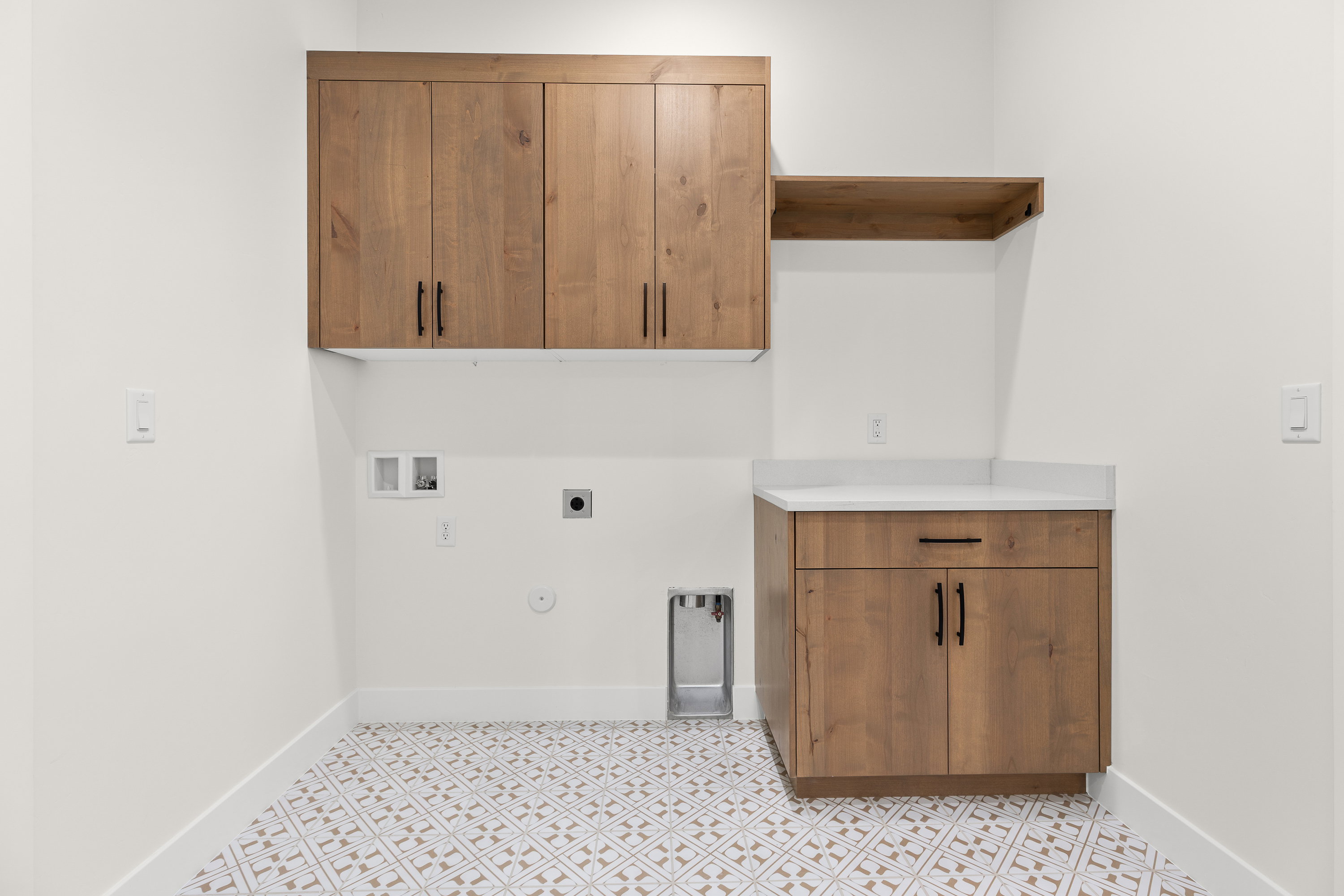 Laundry area with gas dryer hookup, hookup for a washing machine, electric dryer hookup, cabinet space, and light flooring