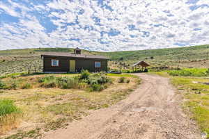 View of home's exterior featuring a rural view and driveway