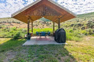 View of green lawn with a patio