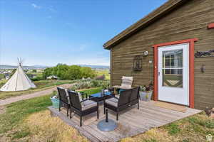 Wooden deck featuring an outdoor lounge area, a mountain view, and a yard