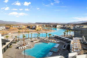 Community pool featuring a mountain view, a residential view, and a patio