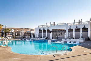Community pool featuring a patio and a hot tub
