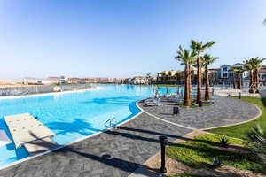 Community pool with a residential view