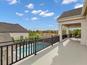 Balcony featuring view of pool