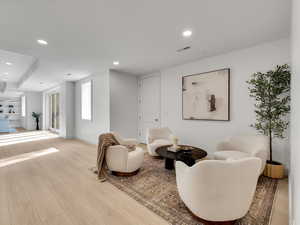 Living area featuring recessed lighting and light wood-style flooring