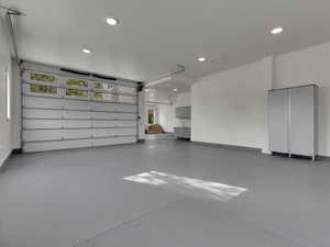 Garage featuring recessed lighting and baseboards
