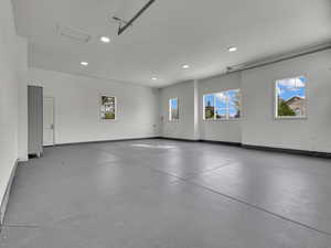 Garage featuring baseboards and recessed lighting