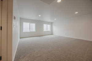 Unfurnished room with light carpet and recessed lighting