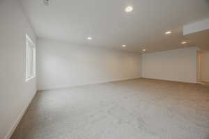 Spare room with light colored carpet and recessed lighting