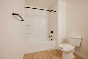 Bathroom featuring light wood-style flooring and shower / bathtub combination