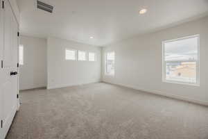 Unfurnished room with light carpet and recessed lighting